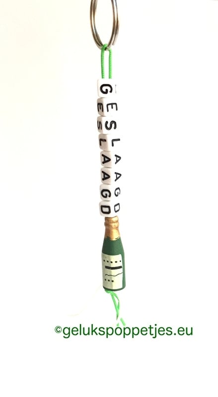 Graduation keyring with lucky charm and wine bottle