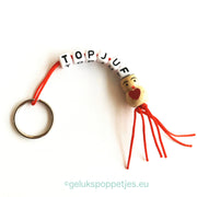Keyring top teacher with lucky doll heart on the belly