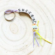 Key chain success with wooden good luck doll