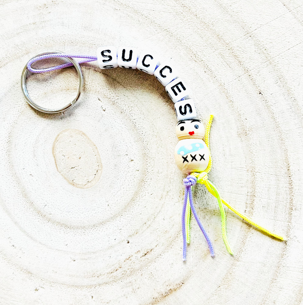 Key chain success with wooden good luck doll